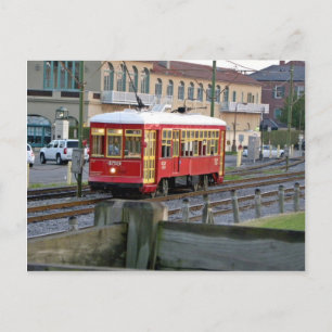 Red electric streetcar on tracks postcard