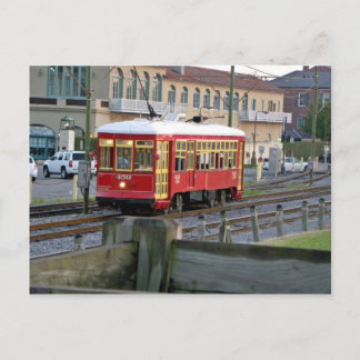 Red electric streetcar on tracks postcard