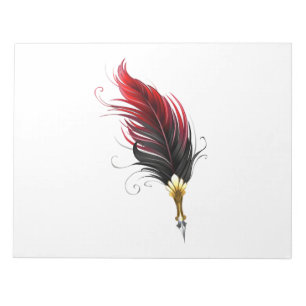 Red feather pen with gold nib notepad