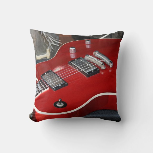 Red guitar on amp cushion (Front)