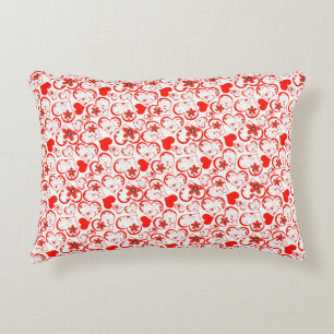 Red hearts and flowers on a white decorative cushion