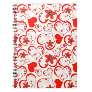 Red hearts and flowers on a white notebook