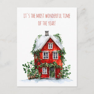 Red house adorned with snow and greenery  holiday postcard