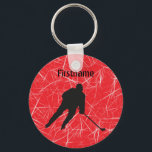 Red ice silhouette hockey player key ring<br><div class="desc">What a great small gift idea for a hockey player or hockey fan - a personalized hockey keychain To carry with keys or to decorate a hockey bag Design: Red ice background silhouette of hockey player in black Personalization with the name of the friend or family member Designed by iceskatingpassion.com...</div>