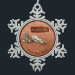 Red Kangaroo In Slouch Hat Snowflake Pewter Christmas Ornament<br><div class="desc">A Red Kangaroo buck, wearing a traditional Australian slouch hat, rests on in the desert. A placard with text reading, "Australia" in a style reminiscent of Aboriginal bark painting, also appears. Add your own additional text. The Red Kangaroo (Macropus rufus) is the largest kangaroo species and Australia's largest terrestrial animal....</div>