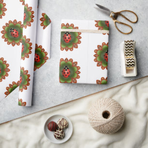 Red ladybug on red and green petals on white. wrapping paper