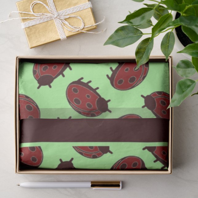 Red ladybugs on green tissue paper (Gift)