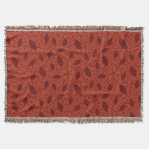 Red leaves pattern on orange throw blanket