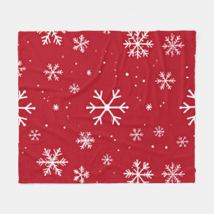 Red pillow with white snowflake pattern fleece blanket