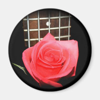 Red pink rose against five string bass fret board