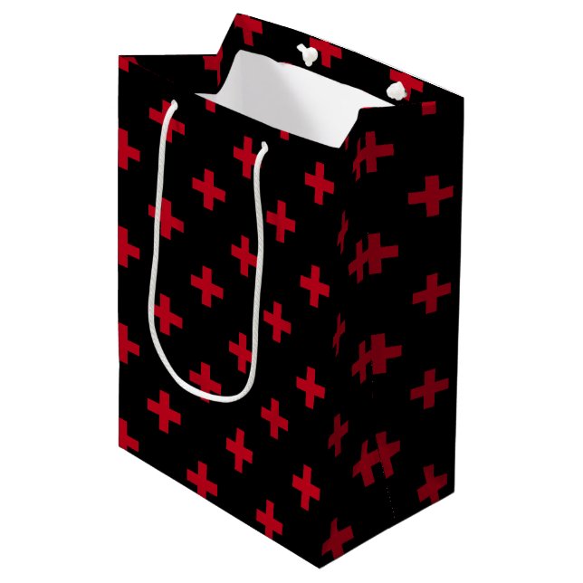 Red polka crosses on black medium gift bag (Front Angled)