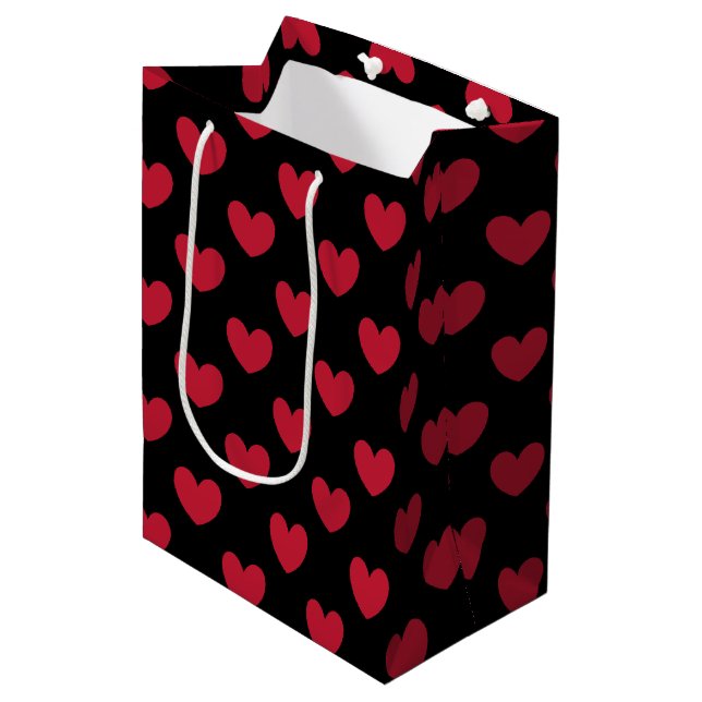 Red polka hearts on black medium gift bag (Front Angled)