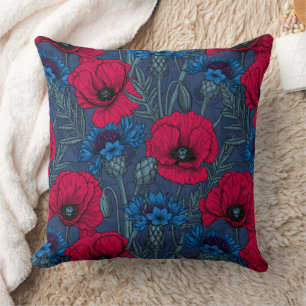 Red poppies and blue cornflowers on blue cushion