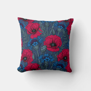 Red poppies and blue cornflowers on blue cushion