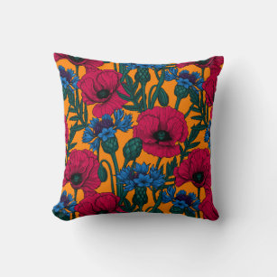 Red poppies and blue cornflowers on orange cushion