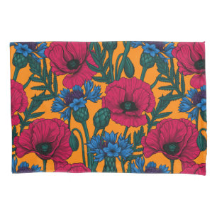 Red poppies and blue cornflowers on orange pillowcase