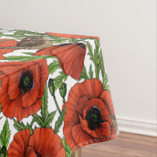 Red poppies and wrens, green leaves on white tablecloth