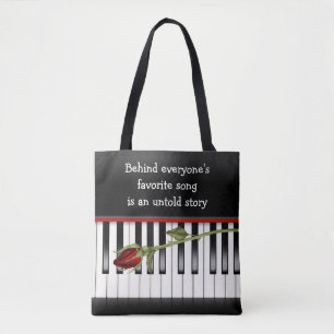 red rose on piano keyboard tote bag