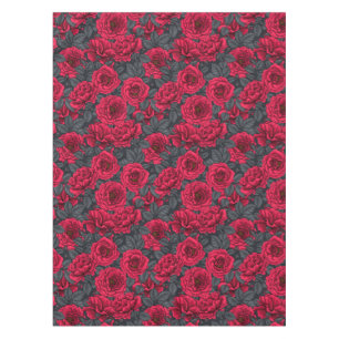 Red roses with grey leaves on black tablecloth