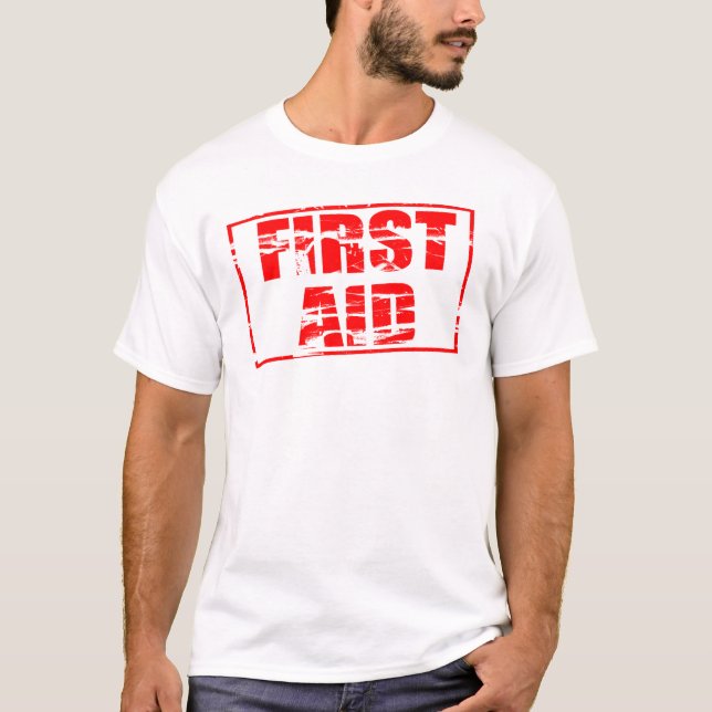 Red rubber stamp effect. First Aid.  T-Shirt (Front)