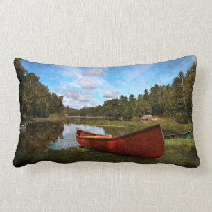 Red rustic canoe on a lake bank lumbar cushion