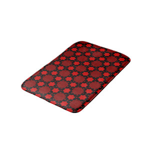 Red stars and shapes on black bath mat