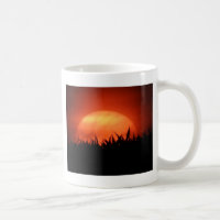 Red sundown behind black grass
