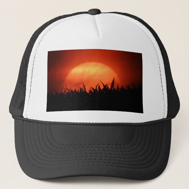 Red sundown behind black grass trucker hat (Front)