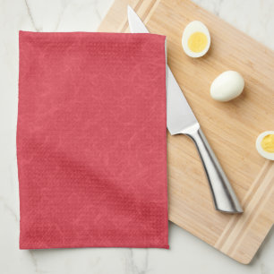 Red textured surface with subtle swirling pattern tea towel