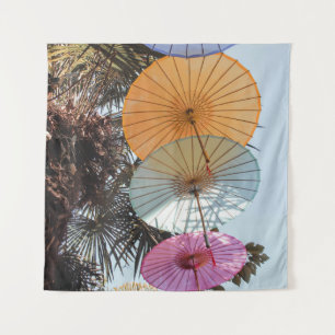 Red umbrella on green tree tapestry
