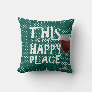 red wine and quote on green cushion