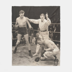 Referee counting over boxer in ringboxing, vintage fleece blanket