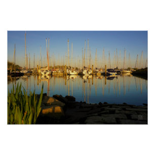 Reflection of boats in a harbor. poster