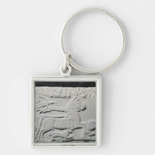 Relief depicting a deer hunt key ring
