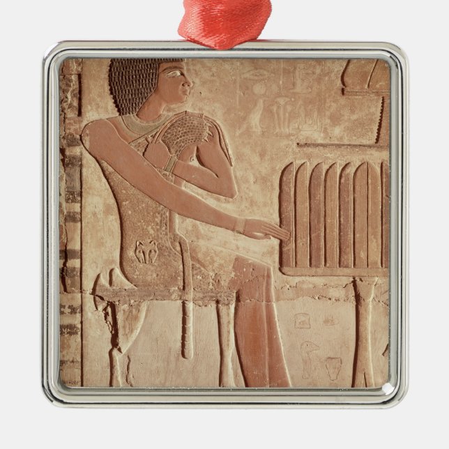 Relief depicting the deceased seated metal tree decoration (Front)