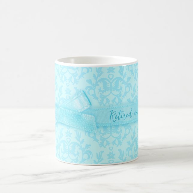 "Retired and loving it" damask pale blue mug (Center)