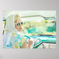 Retro 1950s model driving a vintage turquoise car.