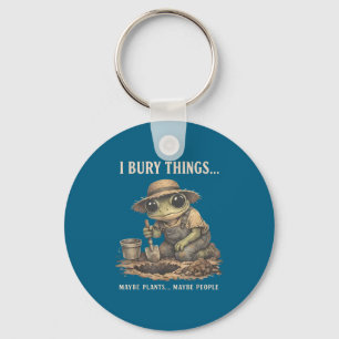 Retro bury things maybe plants maybe people frog key ring