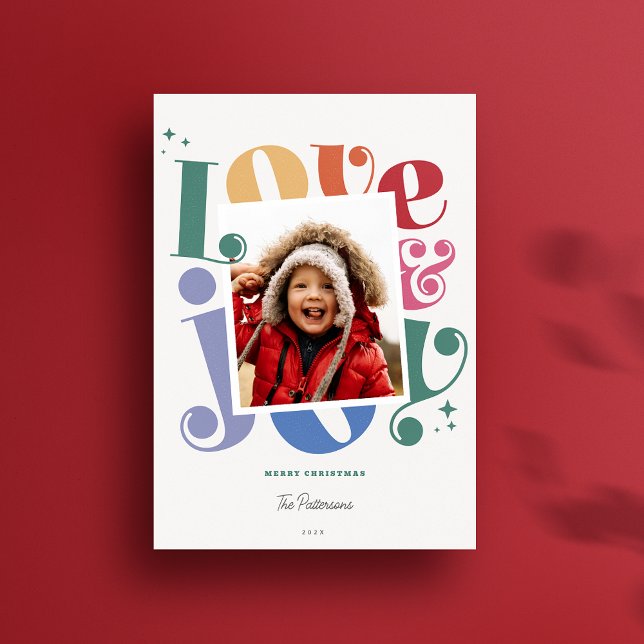 Retro Rainbow Love and Joy 1 photo Christmas Holiday Card (Custom Love and Joy Colorful  modern rainbow 1 photo holiday card shown on a bright red background)