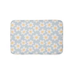 Retro style daisies in bloom on blue background bath mat