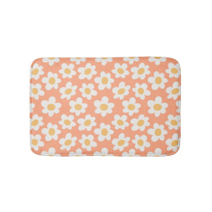 Retro style daisies in bloom on orange background bath mat