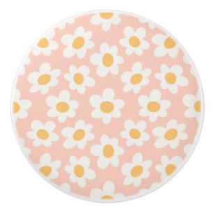 Retro style daisies in bloom on pink background ceramic knob