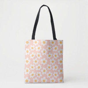 Retro style daisies in bloom on pink background tote bag