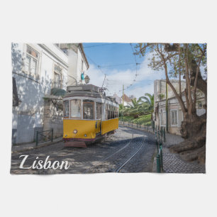 Retro yellow tram on street in Lisbon, Portugal Tea Towel