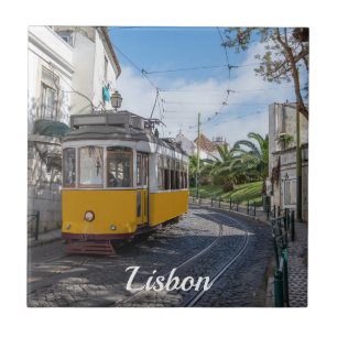 Retro yellow tram on street in Lisbon, Portugal Tile
