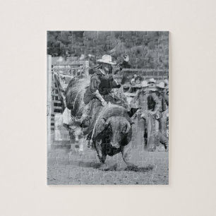 Rider hanging on to bucking bull jigsaw puzzle