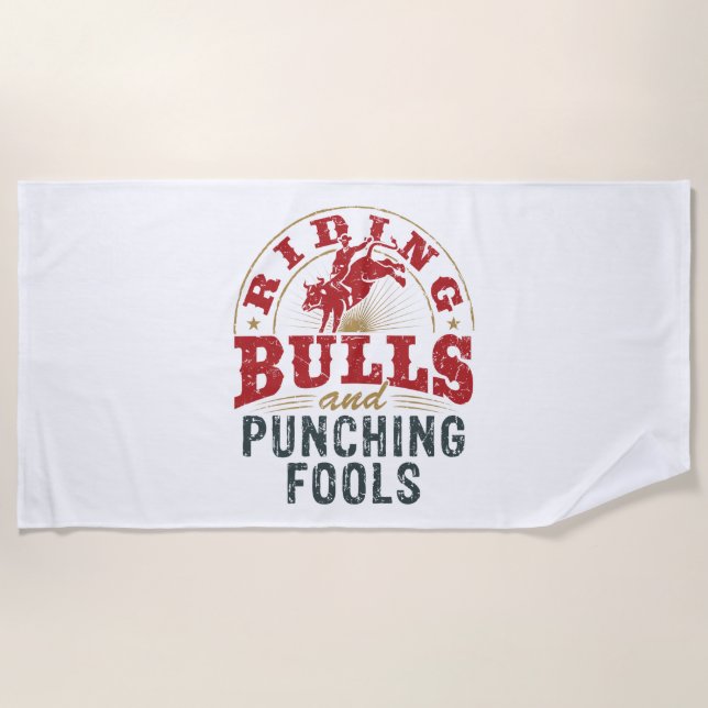 Riding Bulls and Punching Fools Beach Towel (Front)