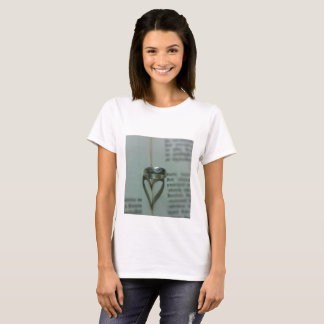 Ring's heart shadow on book page T-Shirt
