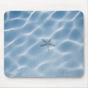 Rippled blue water with starfish mouse mat