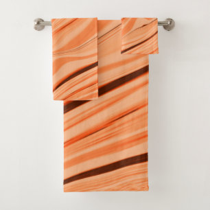 Ripples in shades of orange, curved brown cylinder bath towel set